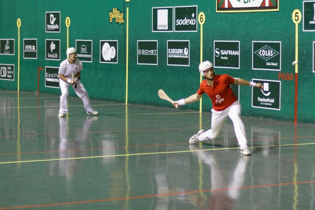 Pelota is played with a curved paddle and a rubber ball.