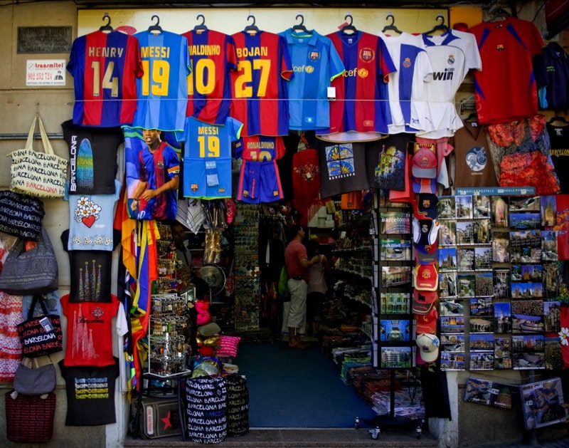 A souvenir shops covered mostly in replica FC Barcelona jerseys. Buying souvenirs is one of the ten things Irish people love to do abroad.