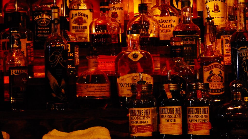 Picture of moonshine bottles in a bar.