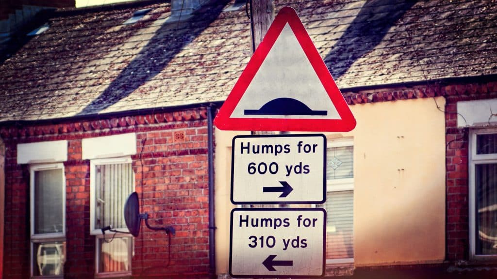 Road signs showing humps to the right and to the left.