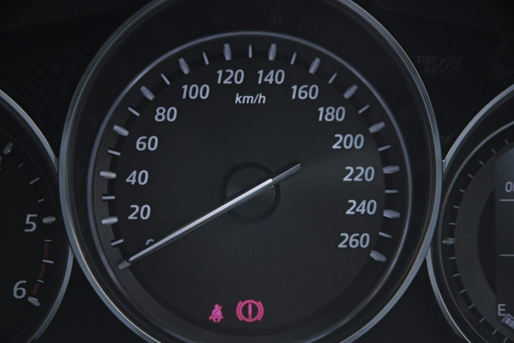 Car dashboard showing km per hour.