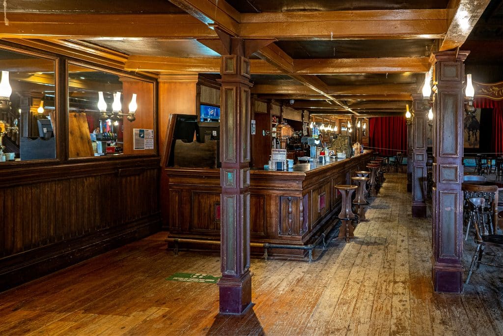 A pub with wooden bar and beams.