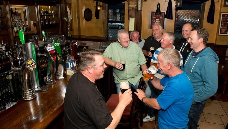 Men at a pub drinking beer.