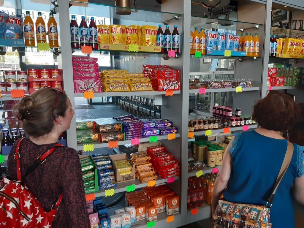 People perusing the Irish food shop abroad selling things like Tayto, Mi Wadi, and more.