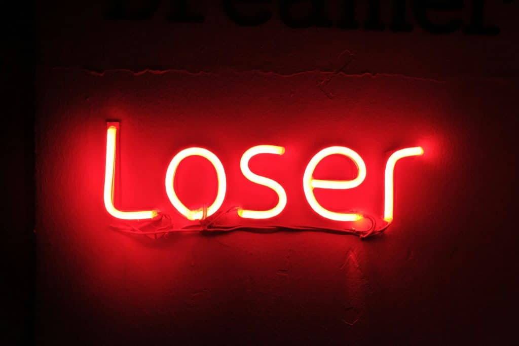 A neon sign reading ‘loser’ in red.